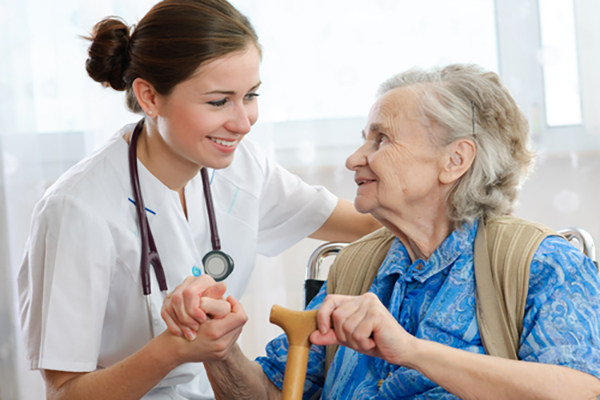 Photo of nurse helping and elderly woman